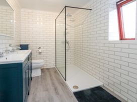 A bathroom with a shower, toilet, and sink at The View in Weymouth