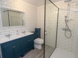 A bathroom with a sink, toilet, and shower at The View in Weymouth