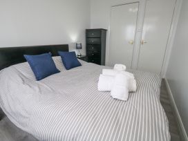 A bedroom with a bed and towels arranged at The View in Weymouth