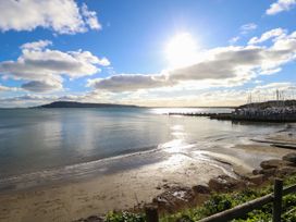 A view of the beach and water under blue sky with clouds at The View in Weymouth