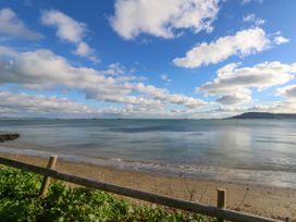 A beach with water and clouds at The View in Weymouth