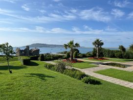A garden with sea view and ruins at The View in Weymouth