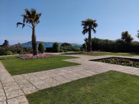 A garden with palm trees and flowers at The View in Weymouth
