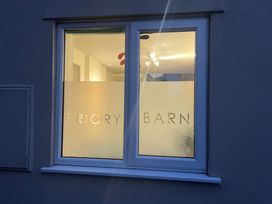 A window with frosted glass and the words Priory Barn on it at Priory Barn Apartment in Walton near Street