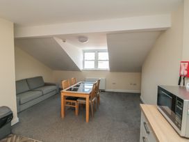 A living room with a sofa and dining table at The Newborough Apartment 5 in Scarborough