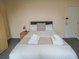 A bedroom with a bed and nightstand at The Newborough Apartment 5 Scarborough