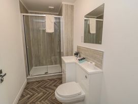 A bathroom with a shower, toilet, and sink at The Newborough Apartment 5 in Scarborough