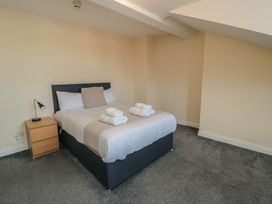 A bedroom with a bed and bedside table at The Newborough Apartment 5 in Scarborough