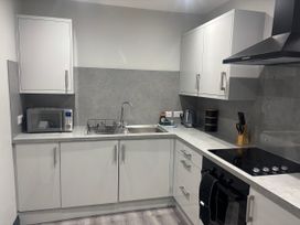 A kitchen with a sink and appliances at The Newborough Apartment 1 Scarborough