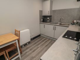 A kitchen with a table and chair at The Newborough Apartment 1 in Scarborough