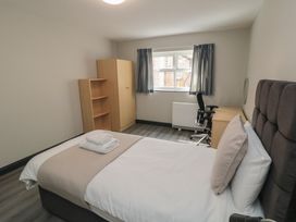 A bedroom with a bed and desk at The Newborough Apartment 1 Scarborough
