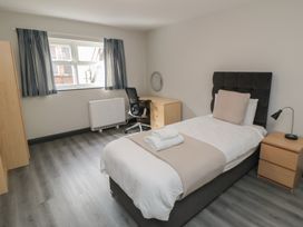 A bedroom with a bed, desk, and chair at The Newborough Apartment 1 in Scarborough