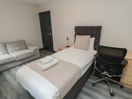 A bedroom with a bed and a sofa at The Newborough Apartment 1 in Scarborough