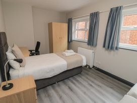 A bedroom with a bed and desk at The Newborough Apartment 1 Scarborough