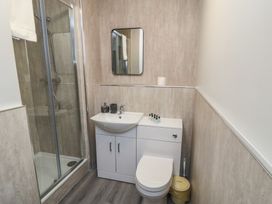 A bathroom with a shower, sink, and toilet at The Newborough Apartment 1, Scarborough