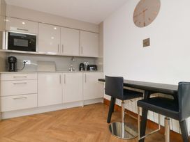 A kitchen with cabinets and appliances at Lodge in Llangefni
