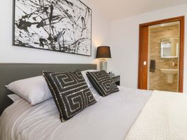 A bedroom with a bed and artwork at Lodge in Llangefni