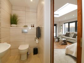A bathroom with a toilet and washbasin at Lodge in Llangefni