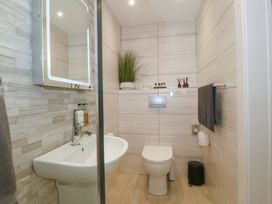 A bathroom with a sink and toilet at Lodge Llangefni