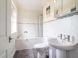 A bathroom with a bathtub, shower enclosure, toilet and sink at Golygfa in Pandy Tudur near Llanrwst