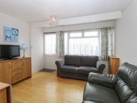 A living room with a sofa and a TV cabinet at 440 California Sands
