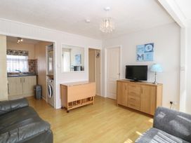 A living room with a television and sofa at 440 California Sands in 