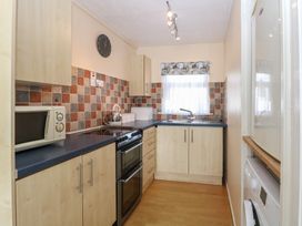 A kitchen with a sink and appliances at 440 California Sands 