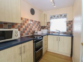A kitchen with countertop, oven, microwave, and sink at 440 California Sands