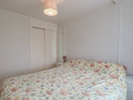 A bedroom with a bed and a bedside lamp at 440 California Sands