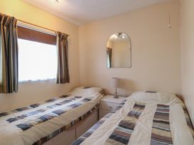 A bedroom with two beds and a lamp at 440 California Sands