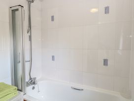 A bathroom with a shower and bathtub at 440 California Sands