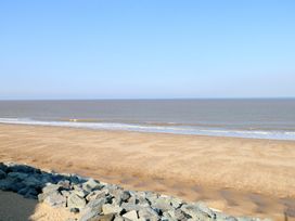 A beach view with sand and rocks at 440 California Sands
