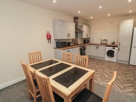 A kitchen with dining table and appliances at The Newborough Apartment 3 in Scarborough