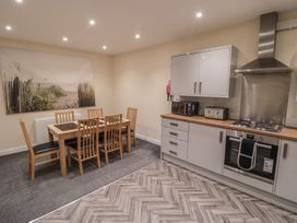 A kitchen with a dining table and chairs at The Newborough Apartment 3 Scarborough