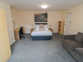 A bedroom with a bed and desk at The Newborough Apartment 3 Scarborough