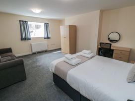 A bedroom with a bed and a desk at The Newborough Apartment 3 Scarborough