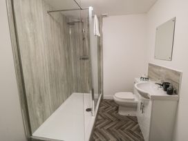 A bathroom with a shower, toilet, and sink at The Newborough Apartment 3 in Scarborough