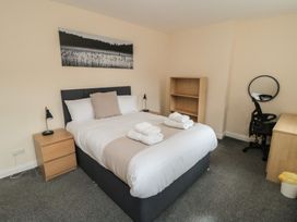 A bedroom with a bed and desk at The Newborough Apartment 3 Scarborough