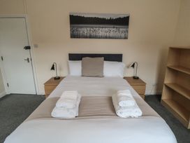 A bedroom with a bed and shelves at The Newborough Apartment 3 in Scarborough