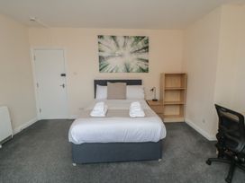 A bedroom with a bed and a storage unit at The Newborough Apartment 3 Scarborough