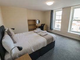 A bedroom with a bed and desk at The Newborough Apartment 4 in Scarborough