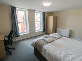 A bedroom with a bed and desk at The Newborough Apartment 4 Scarborough