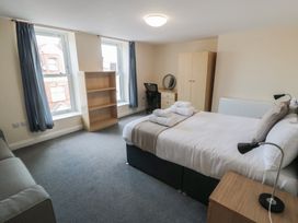 A bedroom with a bed and desk at The Newborough Apartment 4 Scarborough