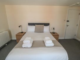 A bedroom with a bed and nightstands at The Newborough Apartment 4 Scarborough