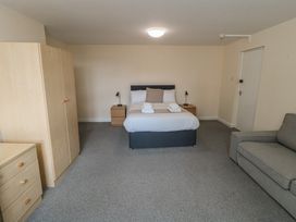 A bedroom with a bed and nightstand at The Newborough Apartment 4 Scarborough