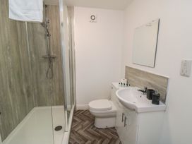 A bathroom with a shower, toilet, and sink at The Newborough Apartment 4 in Scarborough