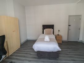 A bedroom with a single bed and wardrobe at The Newborough Apartment 2 in Scarborough