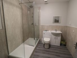 A bathroom with a shower, sink, and toilet at The Newborough Apartment 2 in Scarborough