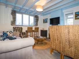 A living room with sofa and armchairs at Puffin Cottage Tintagel