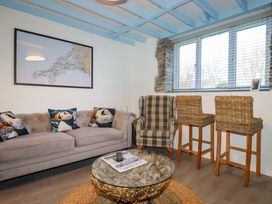 A living room with a sofa and armchair at Puffin Cottage in Tintagel